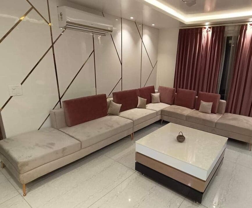 Living room with an L-shaped sofa and maroon curtains
