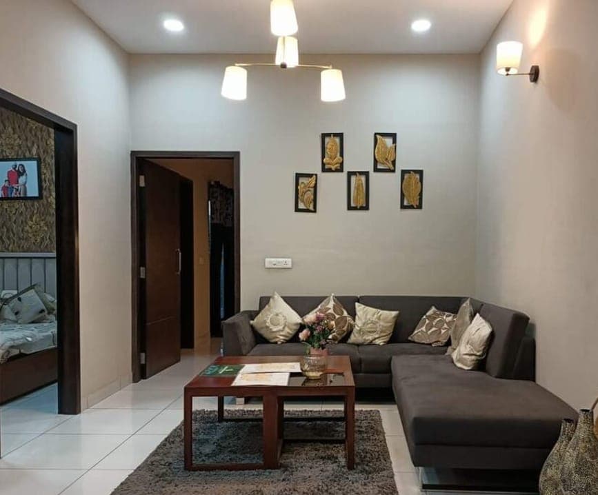 Living room with a dark grey sectional sofa and a shaggy rug